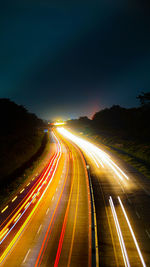 High angle view of light trails on road at night