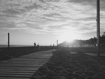 People at beach against sky