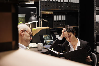 Side view of young woman using laptop while sitting at home