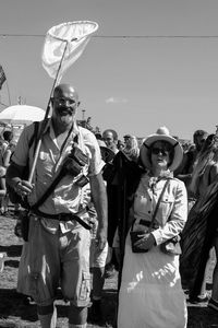 Low angle view of men standing against clear sky