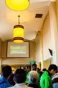 Rear view of people sitting in corridor