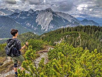 Rear view of teenage boy standing on mountain