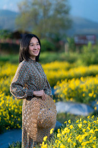 Portrait of a smiling woman on field