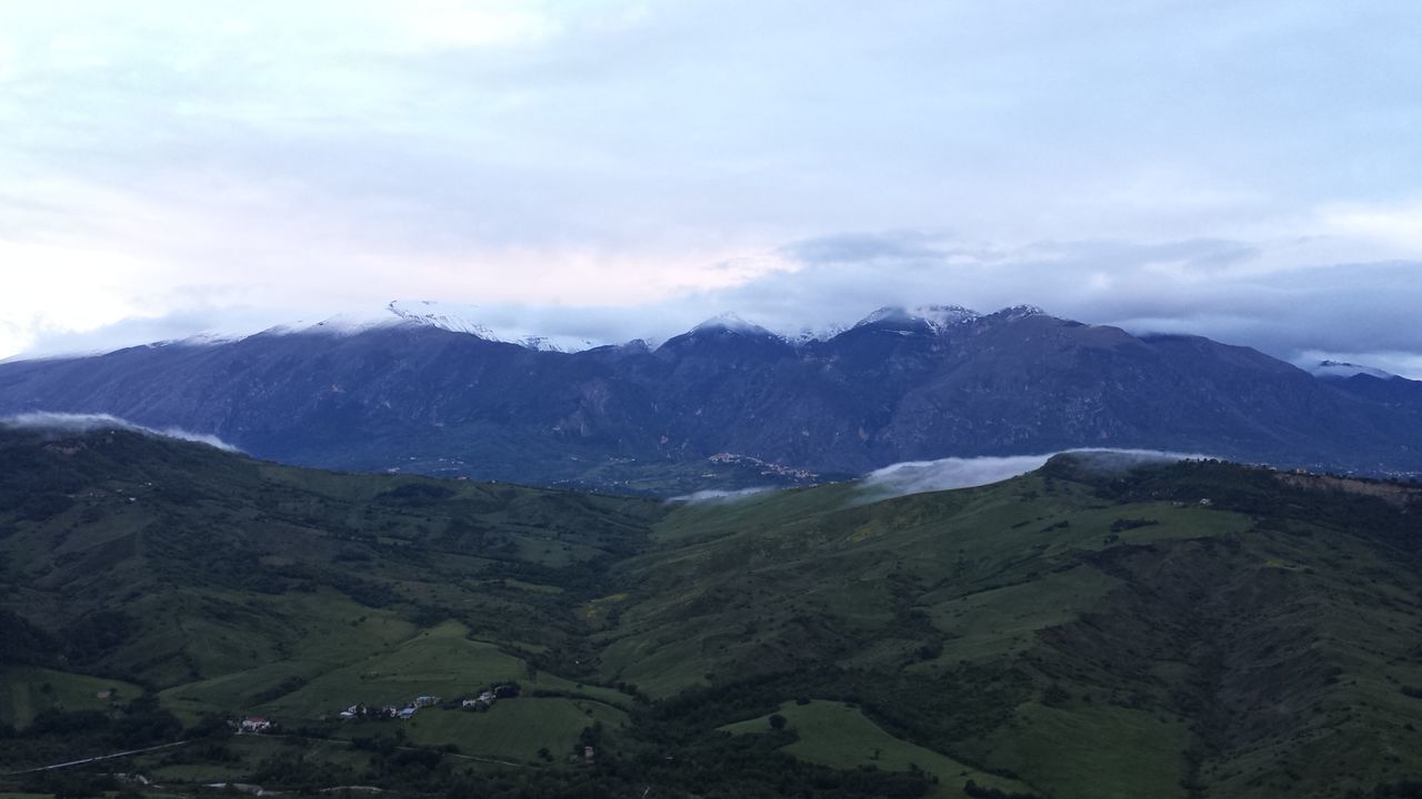 mountain, mountain range, sky, scenics, tranquil scene, beauty in nature, landscape, tranquility, snowcapped mountain, cloud - sky, nature, non-urban scene, snow, cloud, winter, weather, cloudy, mountain peak, idyllic, day