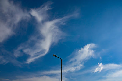 Low angle view of street light against blue sky