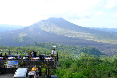 People on mountain against sky