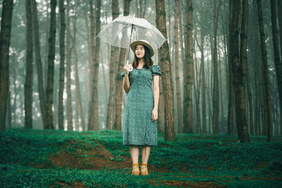 Full length of a woman standing in rain