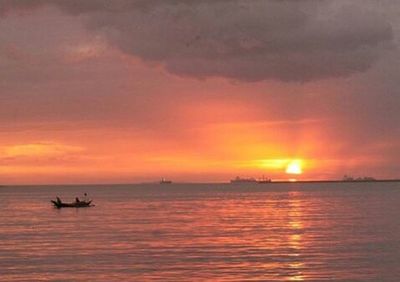 Scenic view of sea against cloudy sky