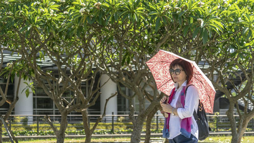 Woman standing by plants