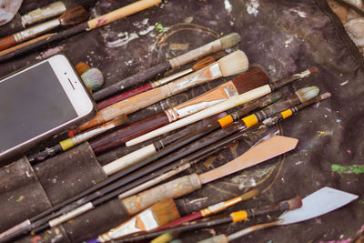High angle view of paintbrushes on floor
