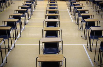 Empty chairs arranged in school hall 