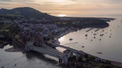 High angle view of townscape by sea against sky