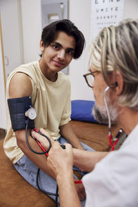 Doctor measuring patient's blood pressure