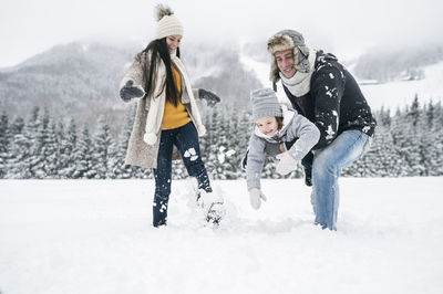 Happy family in winter landscape