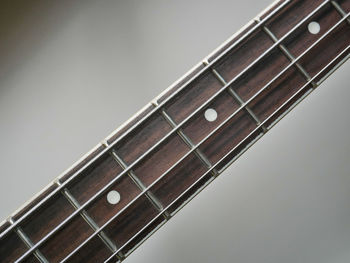 Close-up of guitar against gray background