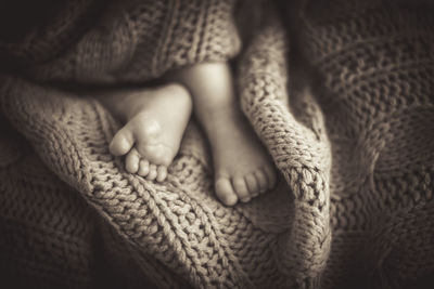 Low section of baby feet on knitted textile