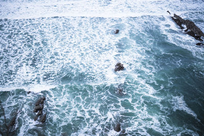 High angle view of people swimming in sea