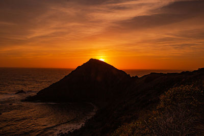 Scenic view of sea against romantic sky at sunset