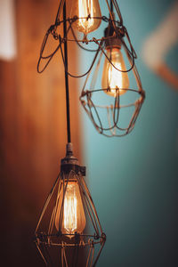 Close-up of illuminated pendant lights hanging in store