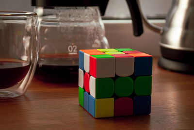 Scrambled rubiks cube in front of handbrewed coffee