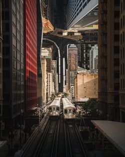 Railroad tracks amidst buildings in city