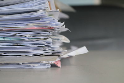Close-up of stacked papers on table