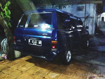 Side view of vehicles on road at night