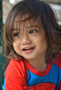 Close-up of cute smiling girl looking away