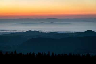 Scenic view of silhouette mountains against sky at sunset