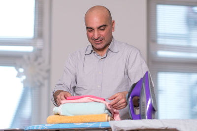 Man holding cloth at home