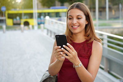 Attractive girl using phone outdoors