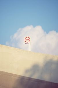 Low angle view of road sign against sky