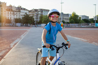 Portrait of man riding bicycle on road