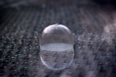 Close-up of frozen bubble on table