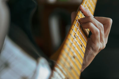 Cropped hand playing guitar