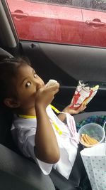 High angle view of cute girl sitting on table