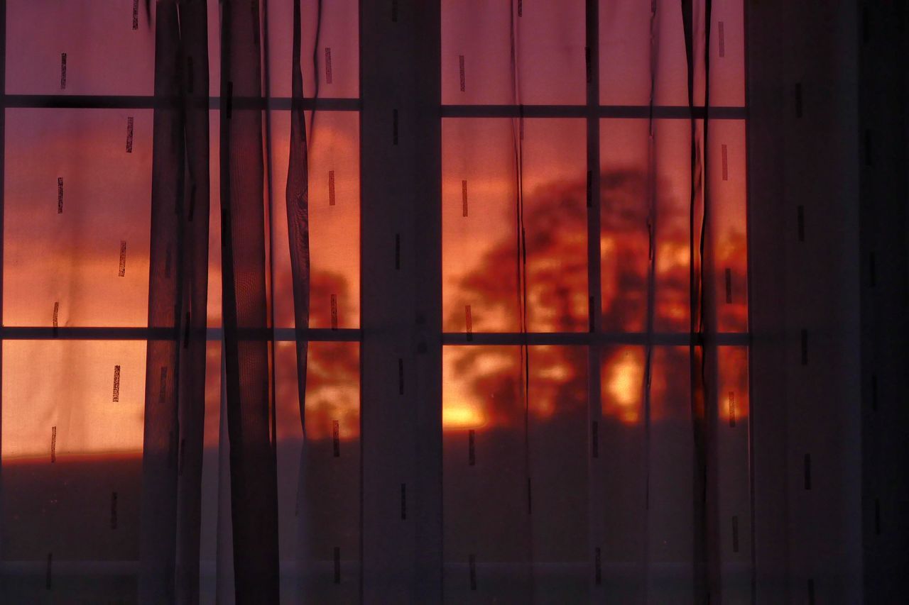 FULL FRAME SHOT OF ORANGE SKY SEEN THROUGH WINDOW