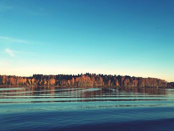 Scenic view of lake against clear blue sky