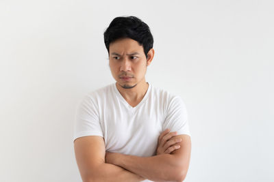 Portrait of young man against white background