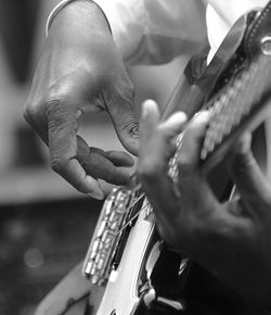 Close-up of man playing guitar