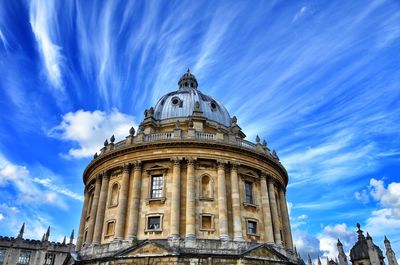 Low angle view of building against cloudy sky