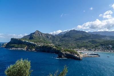 Scenic view of sea and mountains against sky