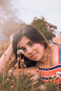 Portrait of smiling young woman holding camera