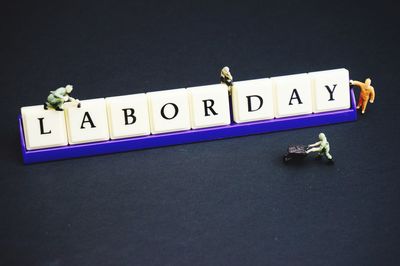 Close-up of information sign on table against black background