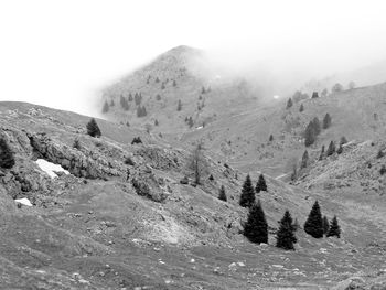 Scenic view of snow covered mountains during foggy weather