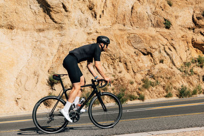 Man riding bicycle on road