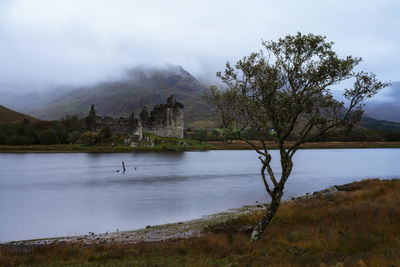 Scenic view of castle and lake against sky