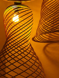 Low angle view of illuminated lamp against orange sky