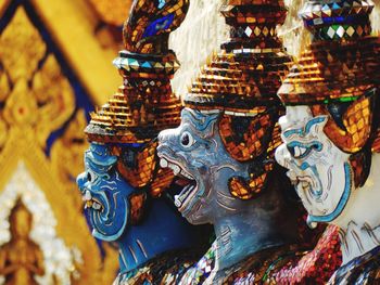 Close-up of statues of demons in buddhist temple