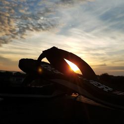 Close-up of silhouette hand against sunset